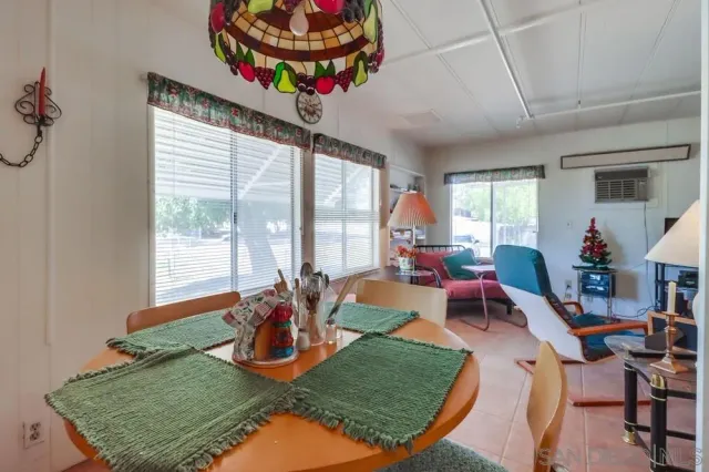 a view of a dining room with furniture a chandelier and wooden floor