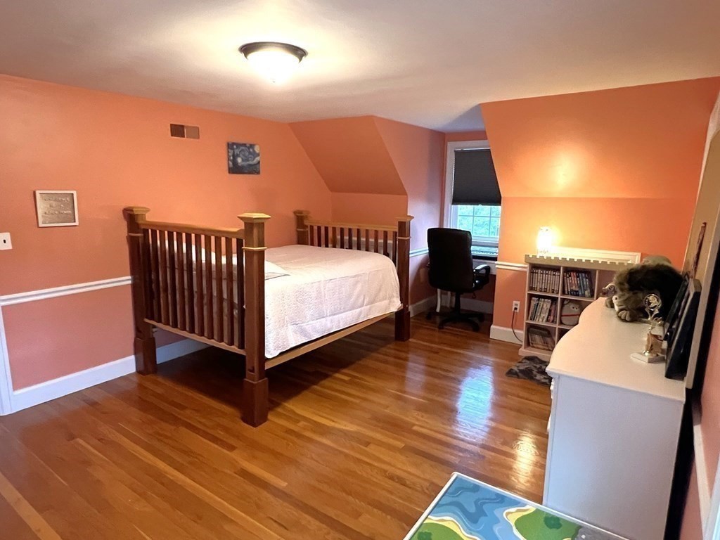 469 Eldridge Street Fall River, MA 02720 - Photo 19 of 40 a spacious bedroom with a bed and wooden floor