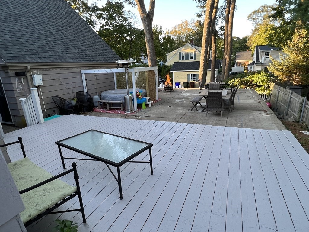 469 Eldridge Street Fall River, MA 02720 - Photo 30 of 40 a view of a patio with table and chairs with wooden floor and fence