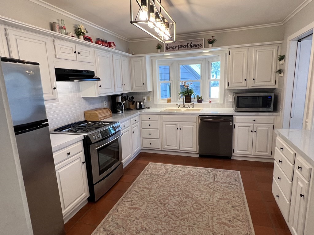 469 Eldridge Street Fall River, MA 02720 - Photo 3 of 40 a kitchen with granite countertop a sink stainless steel appliances and cabinets