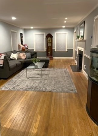469 Eldridge Street Fall River, MA 02720 - Photo 10 of 40 a view of a living room a kitchen island wooden floor and a fireplace