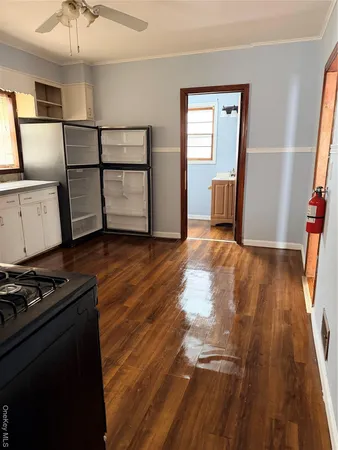 a view of a livingroom with wooden floor and stairs