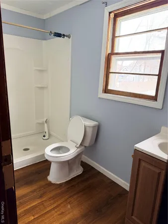 a white toilet sitting next to a bathroom sink