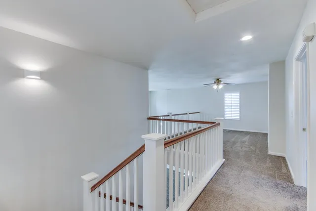 a view of a hallway with stairs