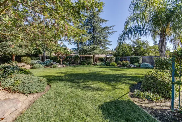 a view of yard with swimming pool and green space