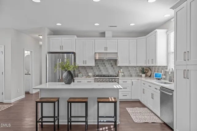 a kitchen with appliances a sink and cabinets