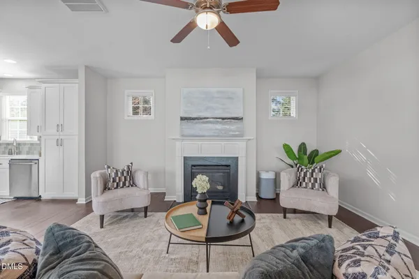 a living room with furniture and a fireplace