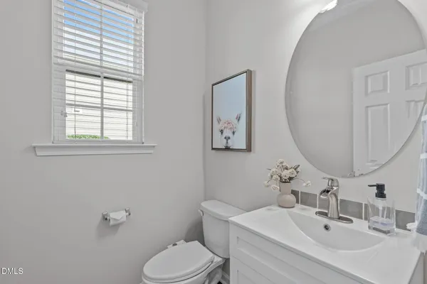 a bathroom with a sink mirror and toilet