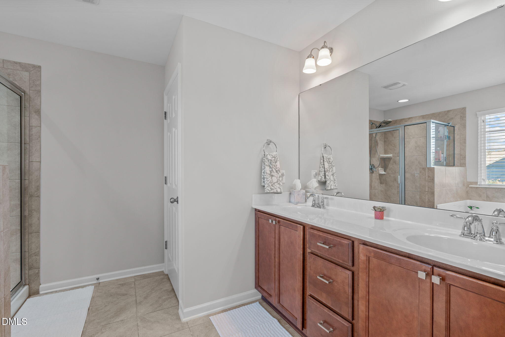 1432 Palace Garden Way Raleigh, NC 27603 - Photo 22 of 42 a bathroom with a double vanity sink and a mirror