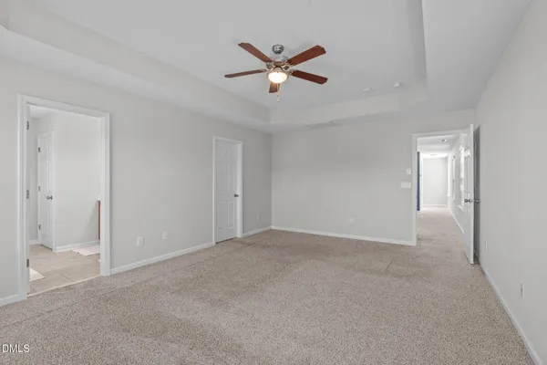 a view of an empty room with a ceiling fan