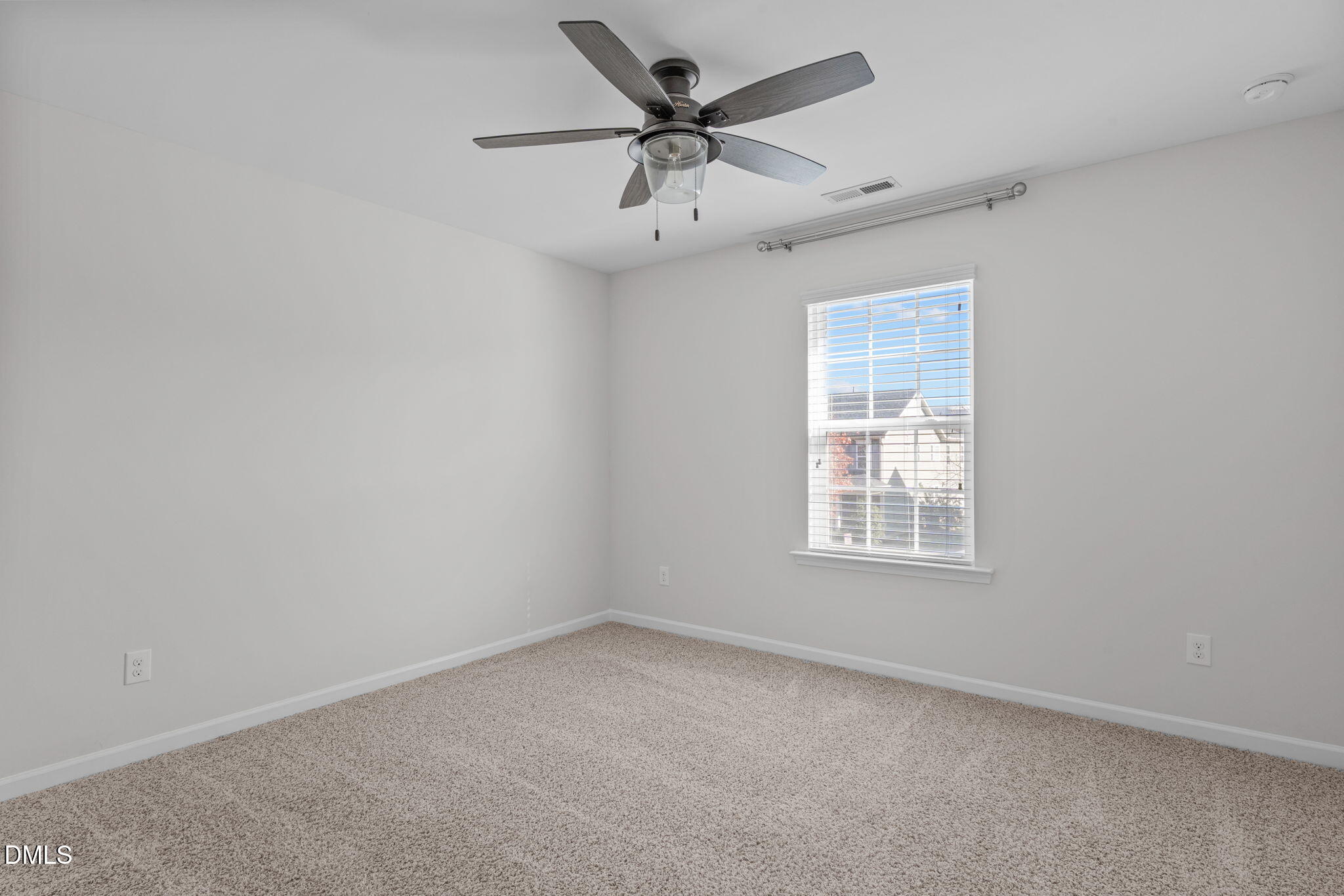 1432 Palace Garden Way Raleigh, NC 27603 - Photo 30 of 40 an empty room with a window and a ceiling fan