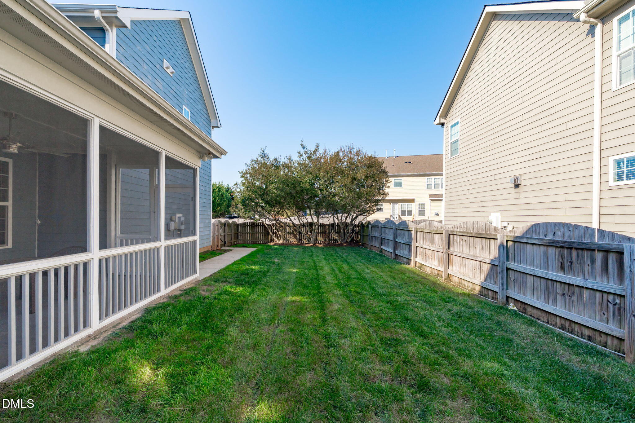 1432 Palace Garden Way Raleigh, NC 27603 - Photo 3 of 40 a view of a backyard with plants and wooden fence