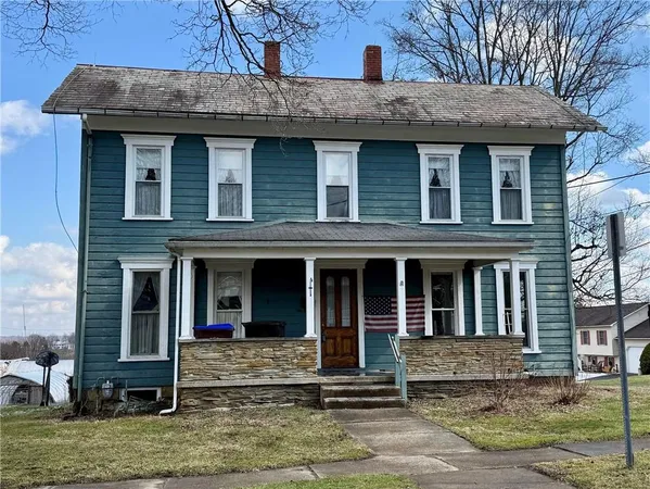 a view of a brick house with large windows