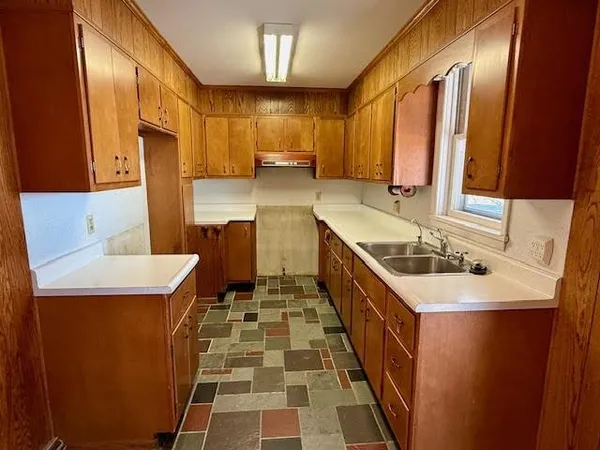 a kitchen with a sink a stove and a refrigerator