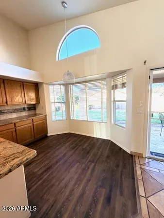 a kitchen with a sink a stove cabinets and wooden floor