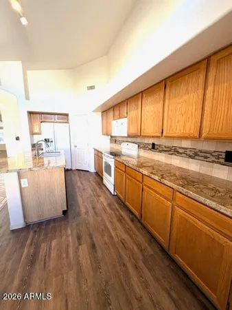 a large kitchen with kitchen island a large window a sink and counter space