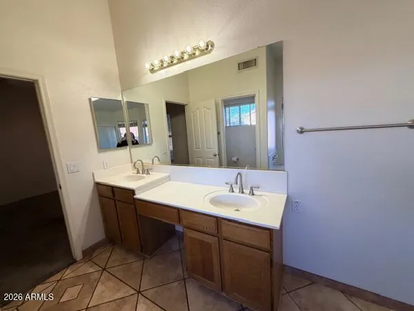 a bathroom with a sink vanity and mirror