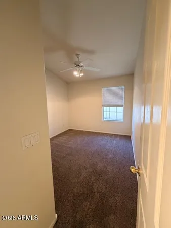 an empty room with windows and closet