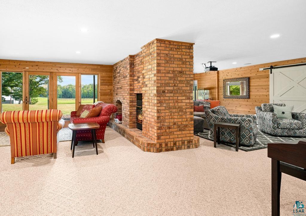 3168 Pioneer Road Barnum, MN 55707 - Photo 35 of 46 The lower level features a wood burning, brick fireplace, walkout patio doors, and two family room areas.