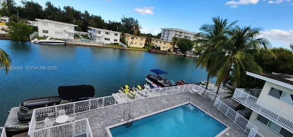 a view of a house with pool and sitting area