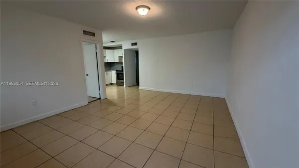 a view of an empty room and a window