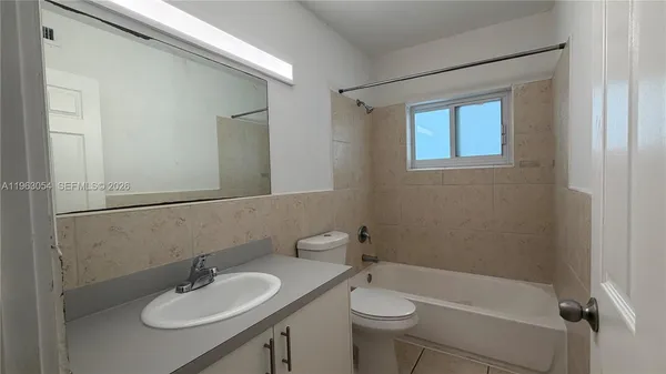 a bathroom with a sink toilet a mirror and shower