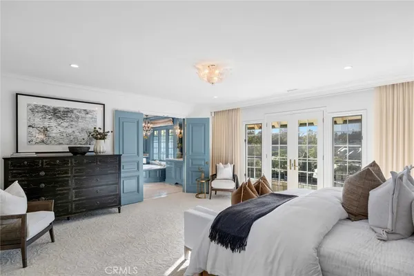 a view of a swimming pool with lawn chairs under an umbrella