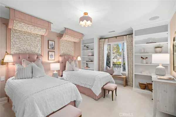 a view of a fountain with a bench in front of house