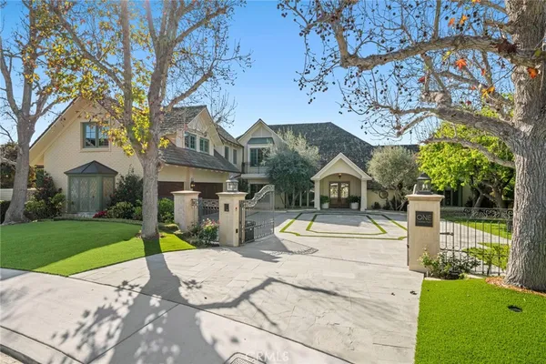 a view of a house with a big yard and large tree