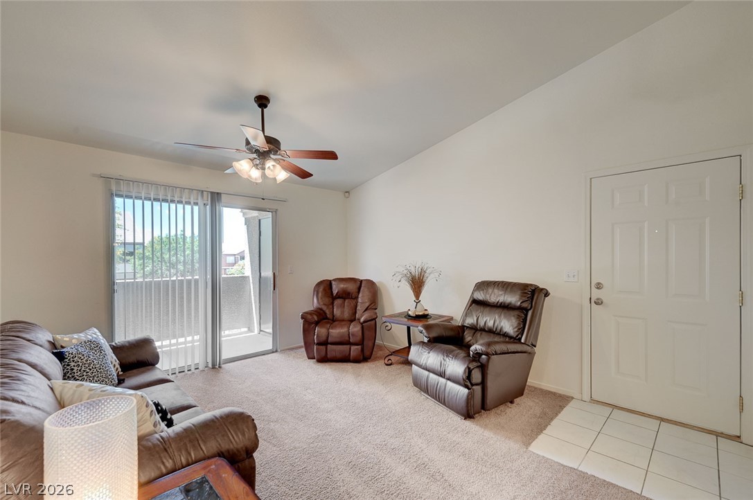 555 East Silverado Ranch Boulevard, Unit 2124 Las Vegas, NV 89183 - Photo 7 of 47 A well-lit gathering space features direct balcony access and comfortable carpeting throughout.
