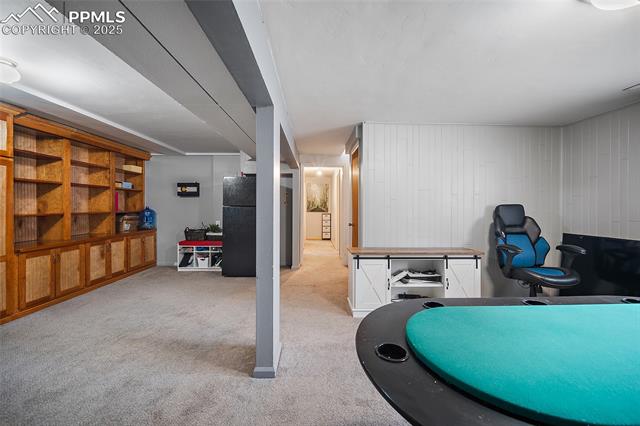 1921 Wooten Road Colorado Springs, CO 80915 - Photo 9 of 49 Exercise area featuring light colored carpet