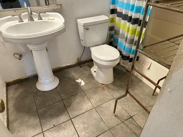 a bathroom with a toilet sink and mirror