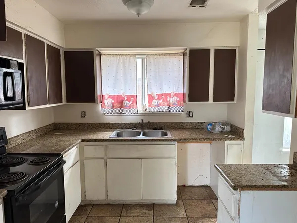 a kitchen with stainless steel appliances granite countertop a sink stove and cabinets