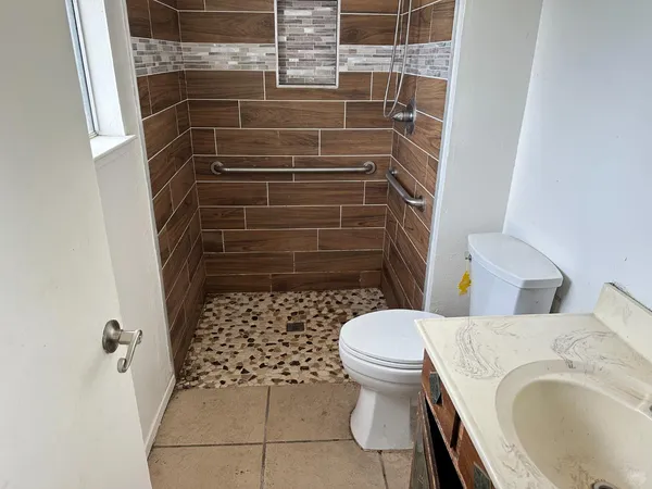 a bathroom with a sink toilet and shower