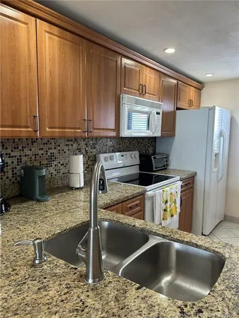 a kitchen with a sink and a stove top oven