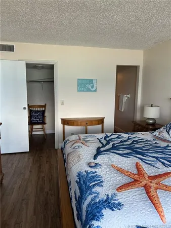 a bedroom with a bed and a lamp