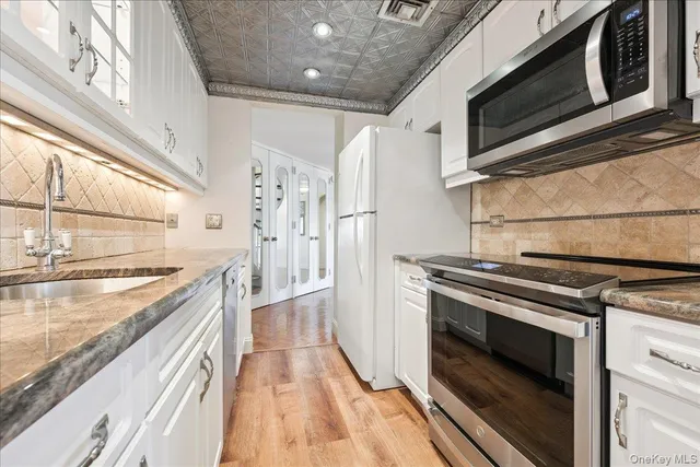a kitchen with stainless steel appliances granite countertop a stove and a microwave