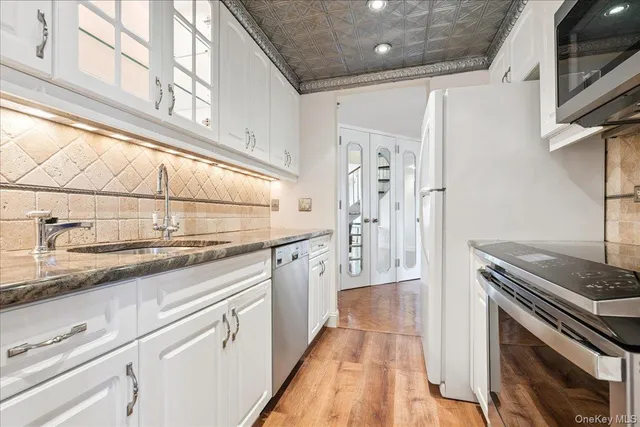 a kitchen with stainless steel appliances granite countertop a sink and a stove
