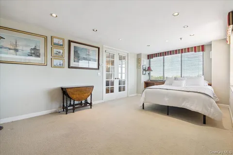 a bedroom with a bed and a desk