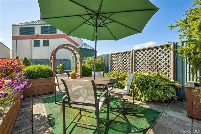 a view of a patio with furniture and a umbrella