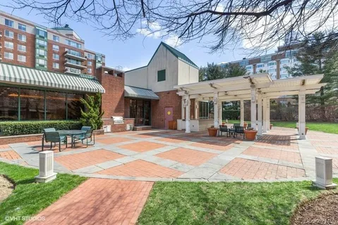 a view of a building with a yard and sitting area