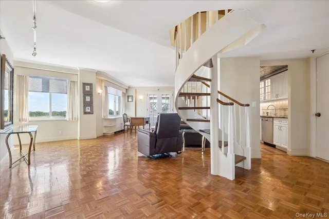 a view of a livingroom with furniture and stairs