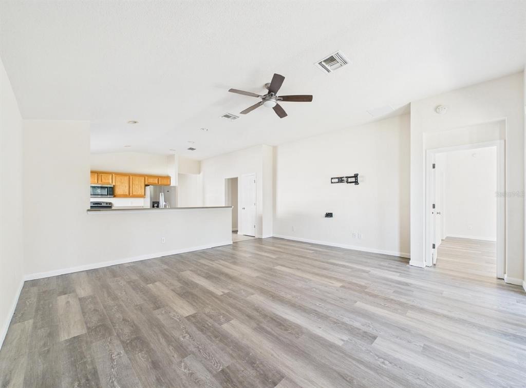 5208 Southwest 39th Street Ocala, FL 34474 - Photo 11 of 55 a view of a room with wooden floor and ceiling fan