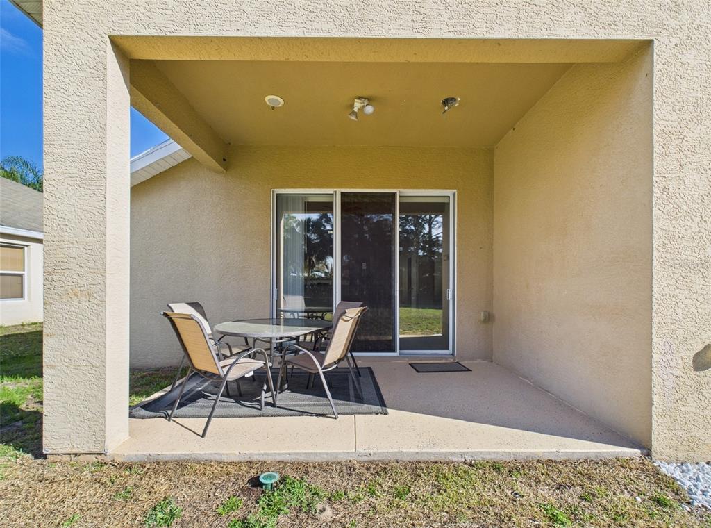 5208 Southwest 39th Street Ocala, FL 34474 - Photo 24 of 55 a view of a patio with a table and chairs