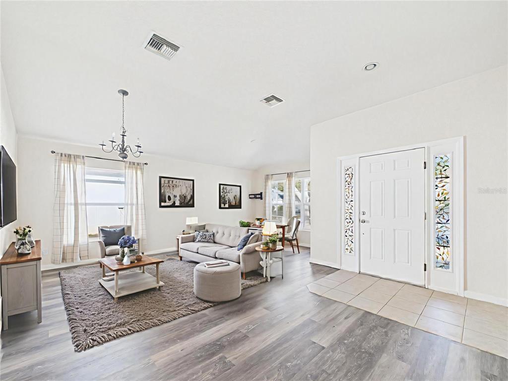 5208 Southwest 39th Street Ocala, FL 34474 - Photo 4 of 55 a living room with furniture and wooden floor