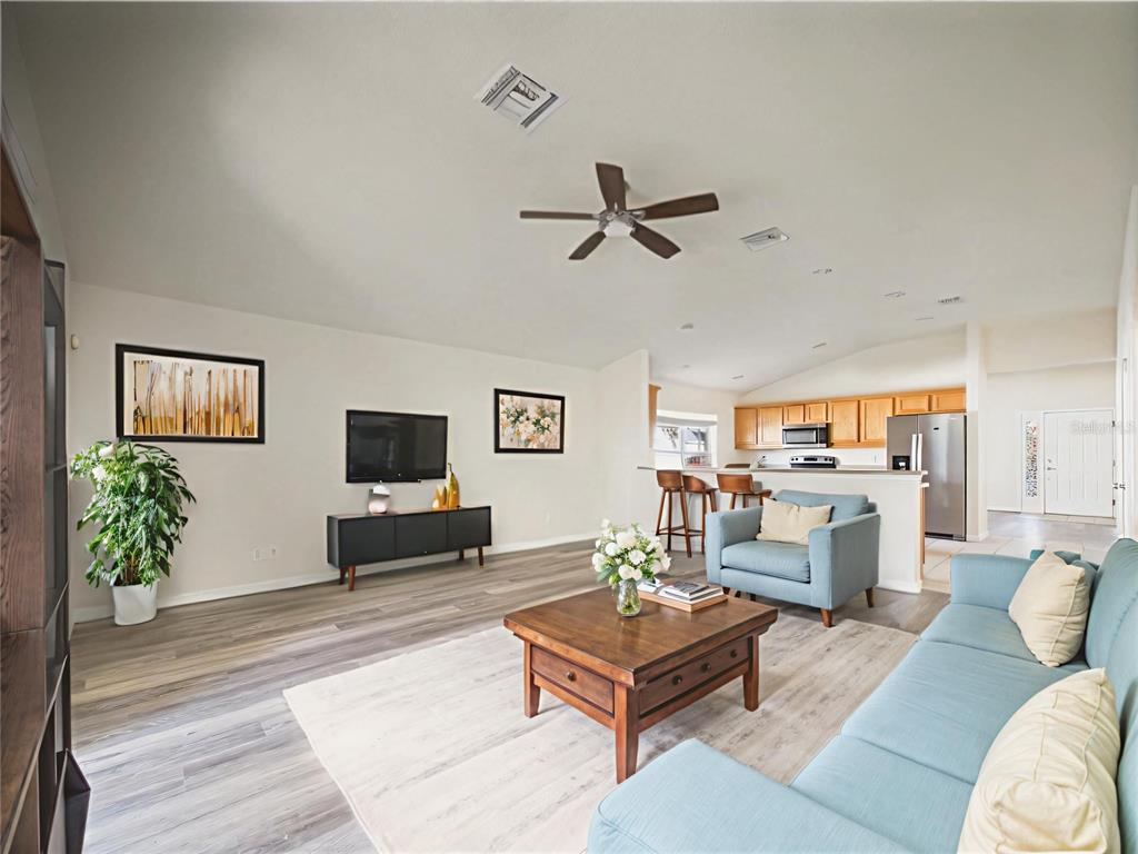 5208 Southwest 39th Street Ocala, FL 34474 - Photo 6 of 55 a living room with furniture and a flat screen tv