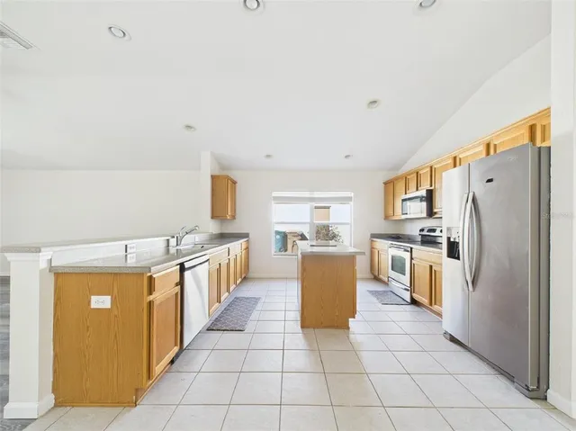 a kitchen with a stove sink and cabinets