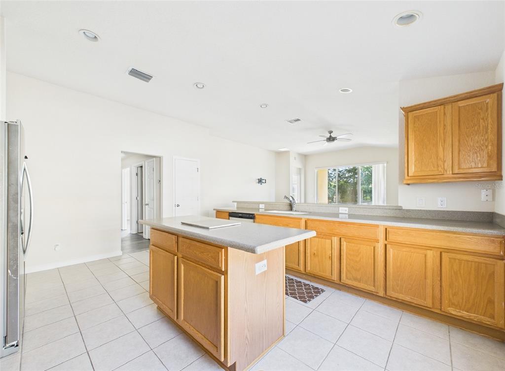 5208 Southwest 39th Street Ocala, FL 34474 - Photo 9 of 55 a kitchen with a stove sink and cabinets