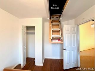 216-11 73rd Avenue, Unit DUPLEX Queens, NY 11364 - Photo 16 of 27 a view of walk in closet with window and wooden floor