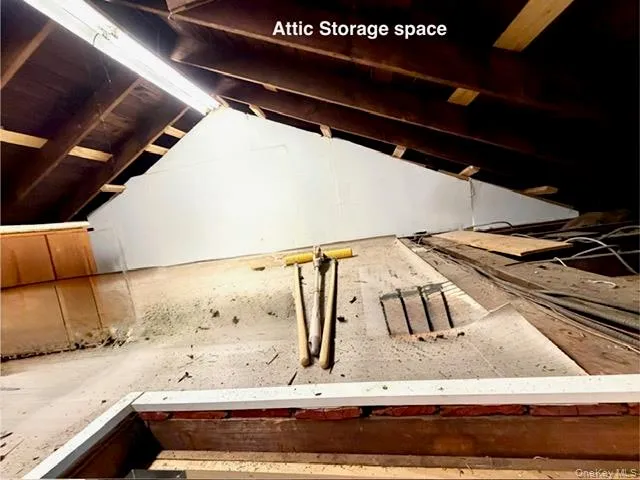 a view of walk in closet with window and wooden floor